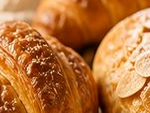 Almond pastry beside a croissant